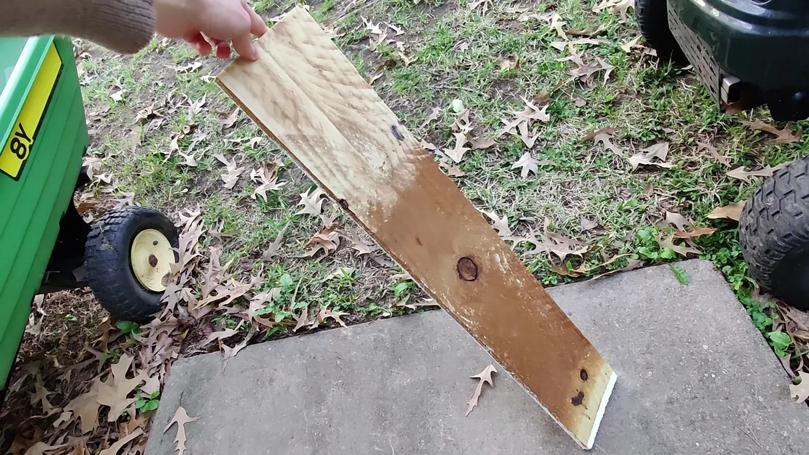 Close-up of a rough, painted piece of pallet wood with visible wear and tear.