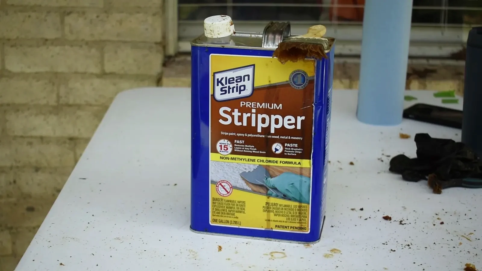 Applying gel stripper to a cabinet door with a chip brush.