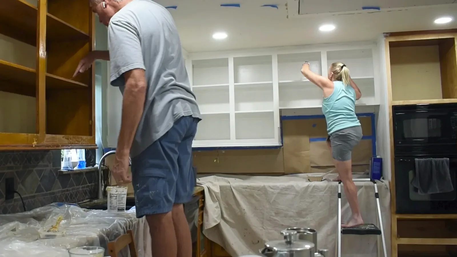 Applying primer to a cabinet door with a small roller.