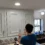 Full view of the kitchen with bright white upper cabinets and new gold hardware.