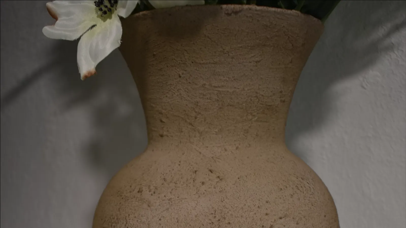 A close-up of the finished stone-look vase, highlighting the textured surface and natural appearance.