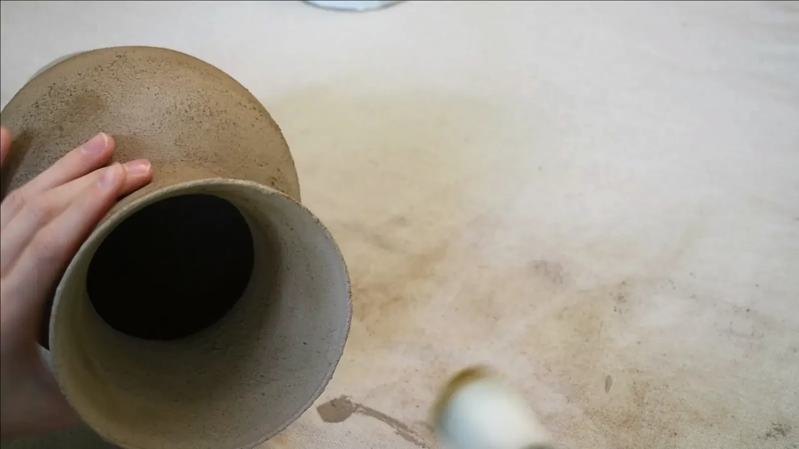 Two finished stone-look vases side-by-side, showing their consistent texture and aged appearance.