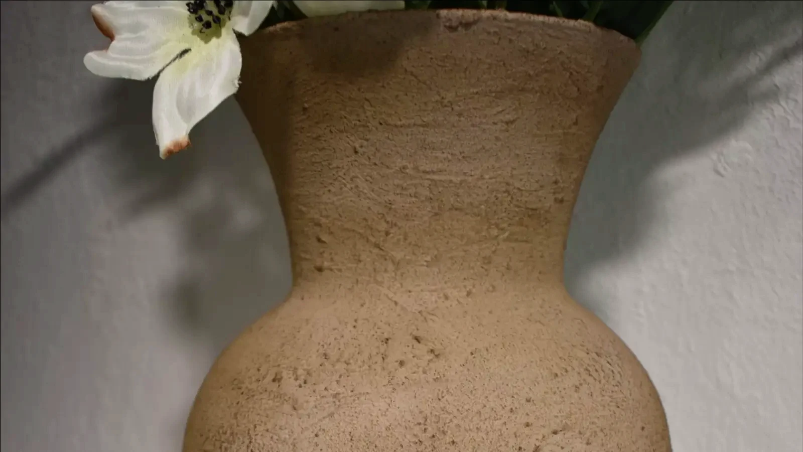 A close-up of the finished stone-look ceramic vase, showcasing its detailed texture and aged finish.